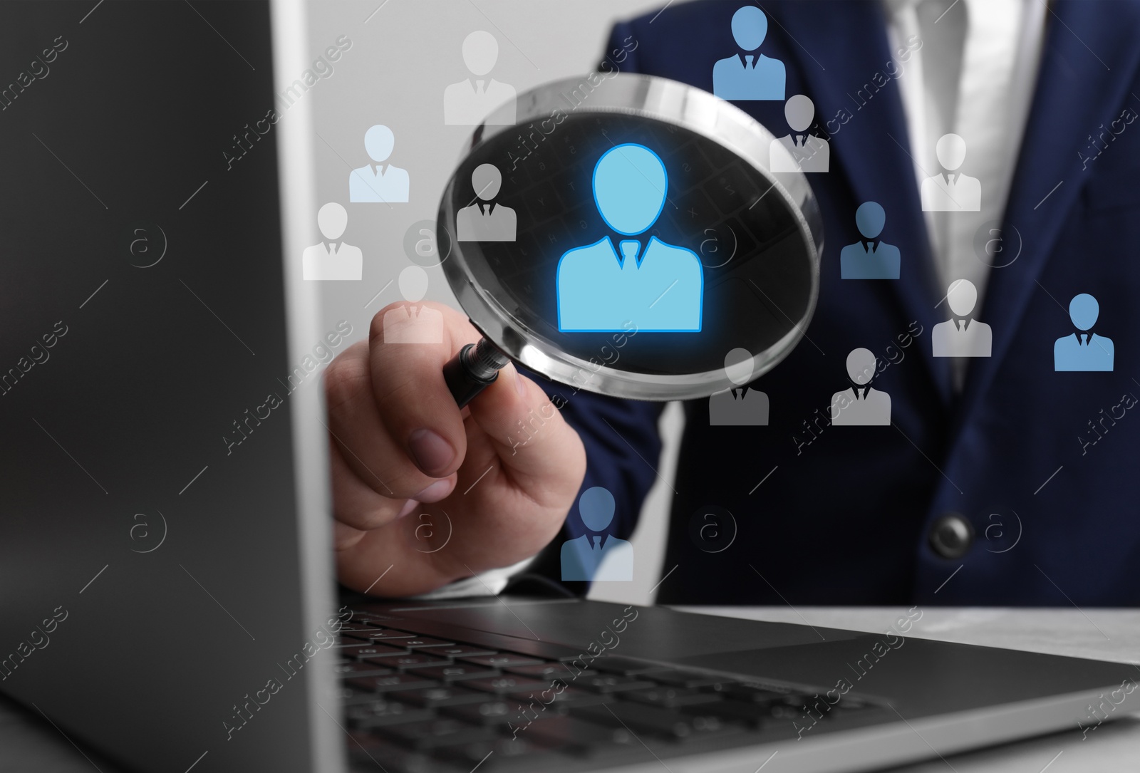Employee search. Man holding magnifier near laptop at wooden table, closeup. Human icons as candidates Image of Employee search. Man holding magnifier near laptop at wooden table, closeup. Human icons as candidates
