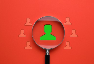 Image of Employee search. Human icons and magnifying glass on red background, top view
