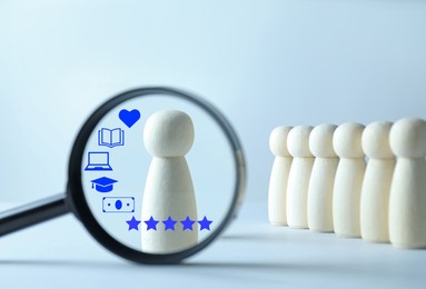 Image of Employee search. Pawn standing out, view through magnifying glass