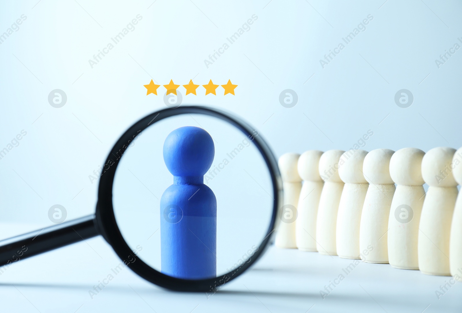 Employee search. Blue pawn among white ones, view through magnifying glass Image of Employee search. Blue pawn among white ones, view through magnifying glass