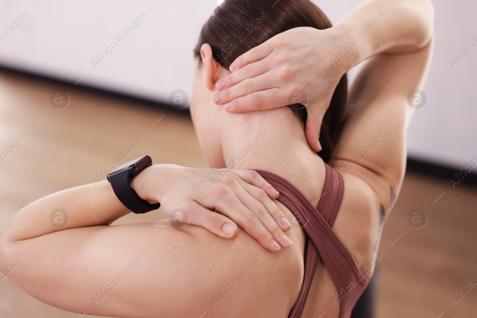 Sports injury. Woman with pain in shoulder indoors Photo of Sports injury. Woman with pain in shoulder indoors