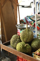 Photo of Fresh ripe durians on counter at market
