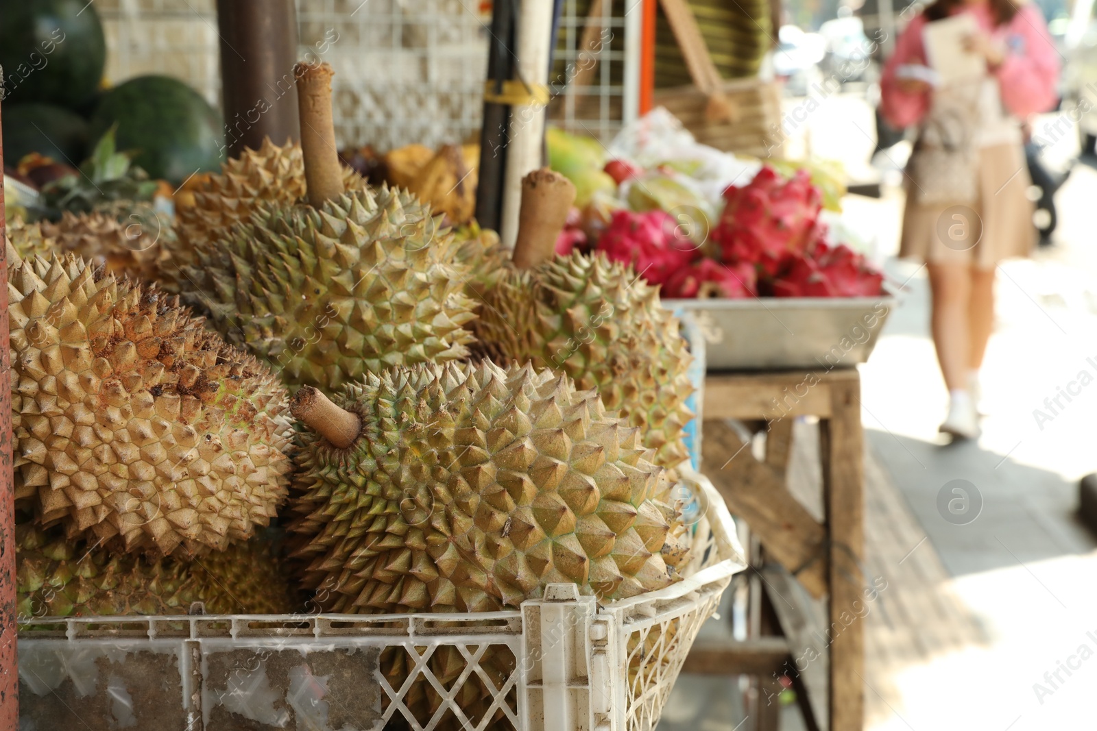 Fresh ripe durians in crate at market, closeup. Space for text Photo of Fresh ripe durians in crate at market, closeup. Space for text