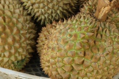Photo of Fresh ripe durians at market, closeup view