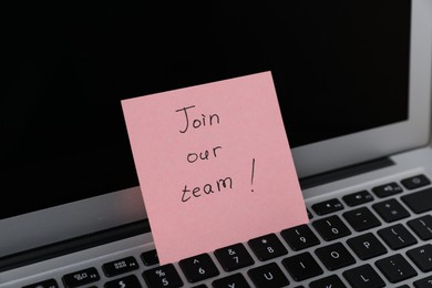 Photo of Sticky note with phrase Join Our Team on laptop, closeup