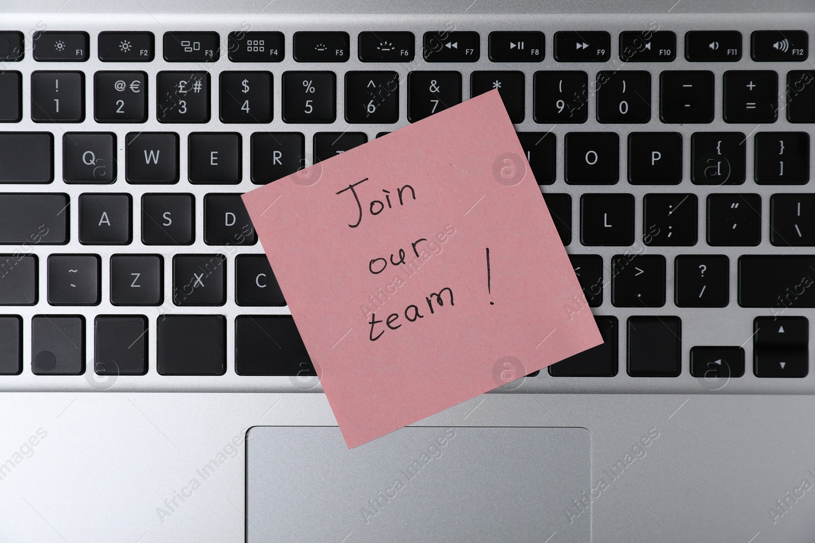 Sticky note with phrase Join Our Team on laptop, top view Photo of Sticky note with phrase Join Our Team on laptop, top view