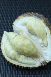 Photo of Fresh ripe durian on wicker table, closeup