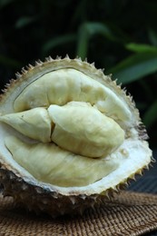 Photo of Fresh ripe durian on table outdoors, closeup