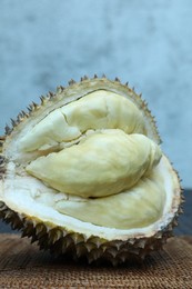 Photo of Fresh ripe durian on table outdoors, closeup