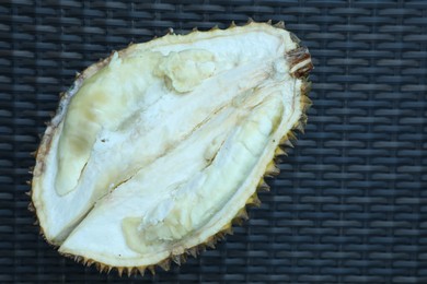 Photo of Fresh ripe durian on wicker table, top view. Space for text