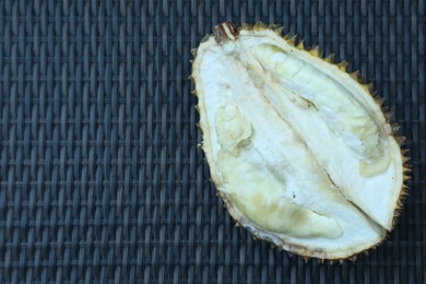 Photo of Fresh ripe durian on wicker table, top view. Space for text