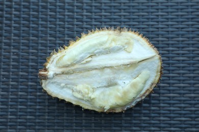 Photo of Fresh ripe durian on wicker table, top view