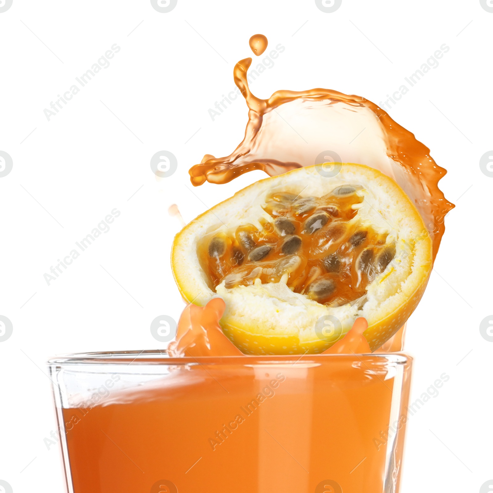 Tasty passion juice splashing out of glass and cut fruit on white background Image of Tasty passion juice splashing out of glass and cut fruit on white background