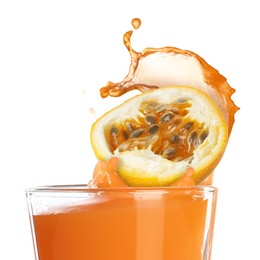 Image of Tasty passion juice splashing out of glass and cut fruit on white background
