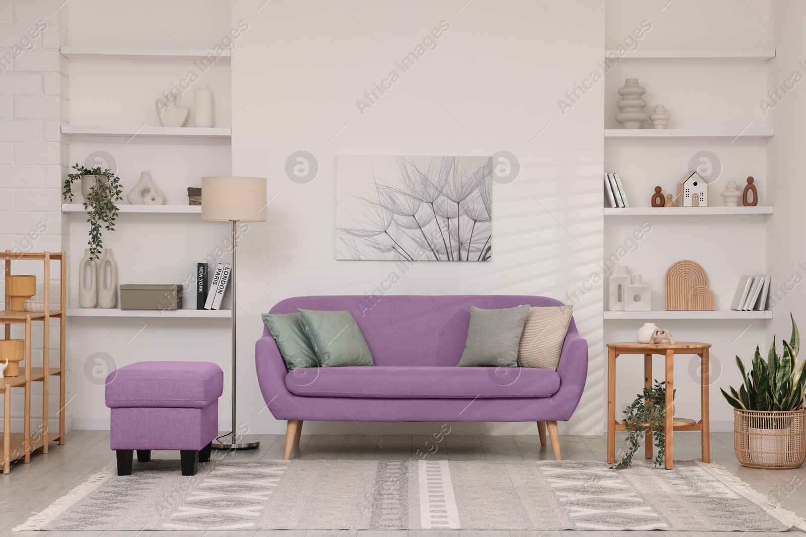 Stylish living room with comfortable sofa and light wall. Interior design Image of Stylish living room with comfortable sofa and light wall. Interior design