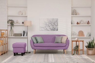 Image of Stylish living room with comfortable sofa and light wall. Interior design