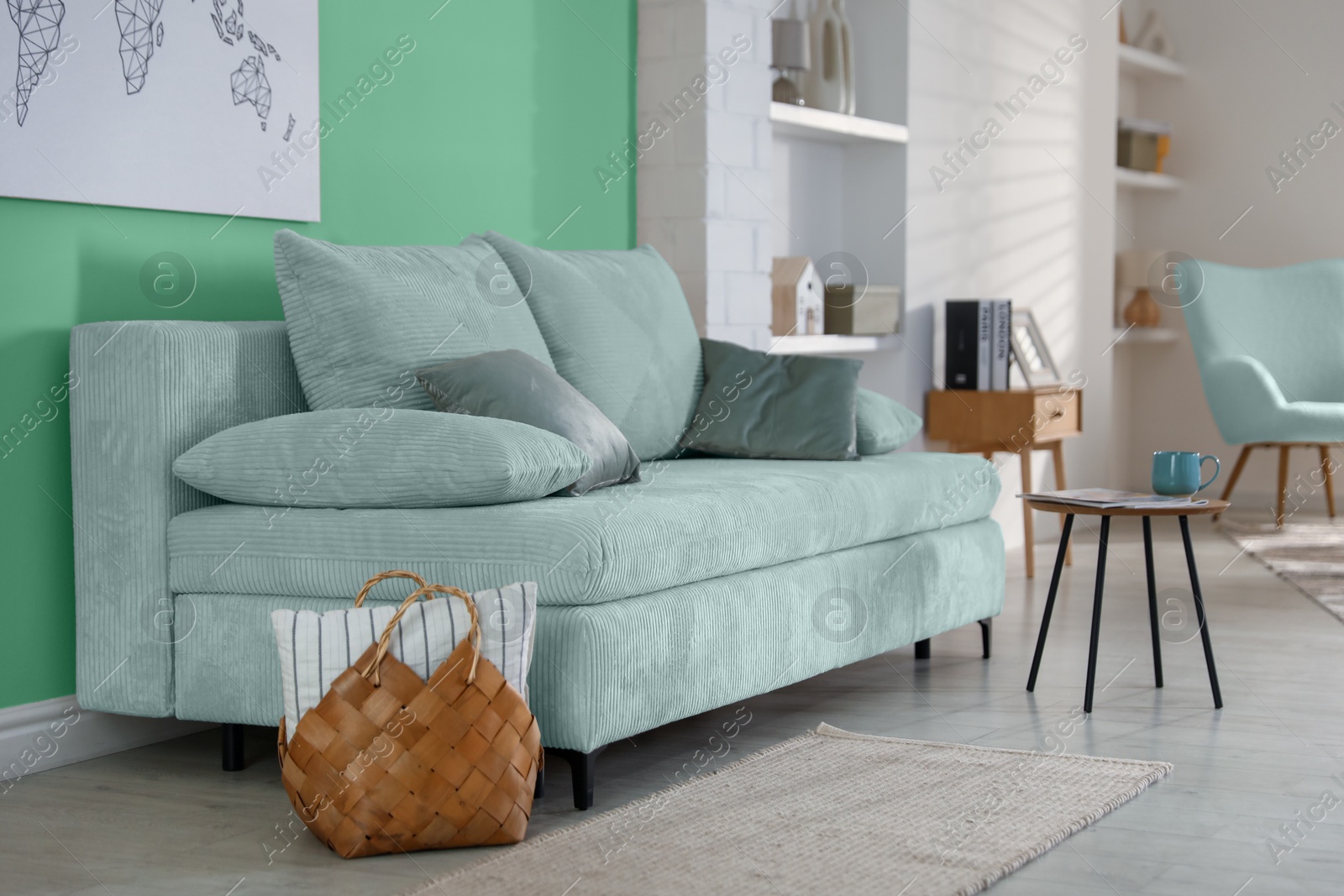 Stylish living room with comfortable mint color sofa and bright wall. Interior design Image of Stylish living room with comfortable mint color sofa and bright wall. Interior design