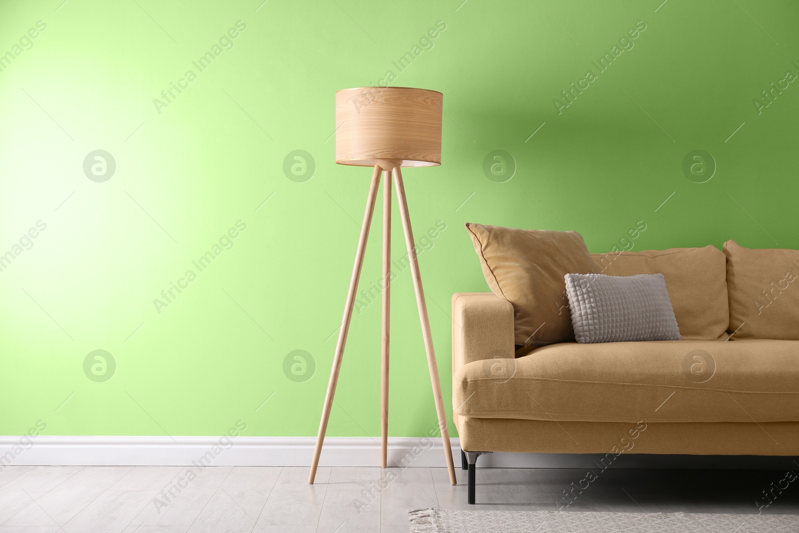 Stylish living room with comfortable sofa and light green wall. Interior design Image of Stylish living room with comfortable sofa and light green wall. Interior design