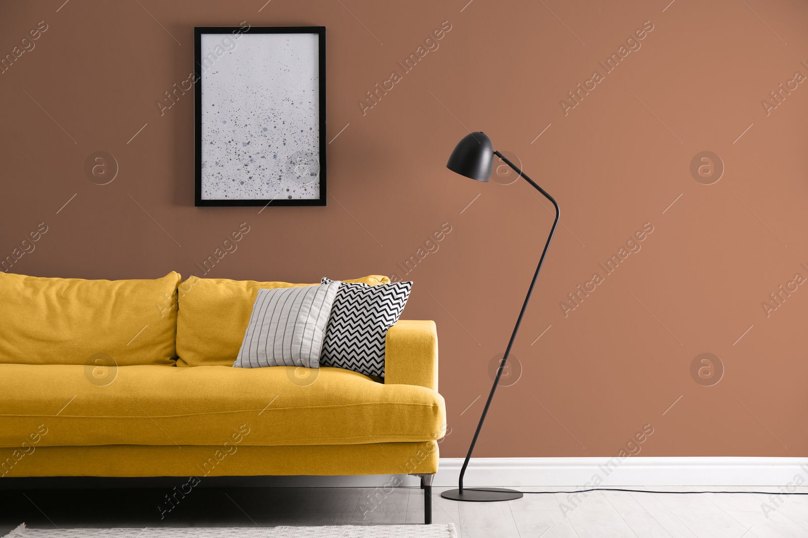 Stylish living room with comfortable sofa and pale brown wall. Interior design Image of Stylish living room with comfortable sofa and pale brown wall. Interior design