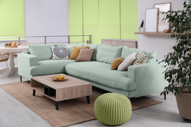 Image of Stylish living room with comfortable mint color sofa. Interior design