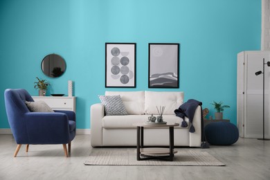 Image of Stylish living room with comfortable sofa and light blue wall. Interior design