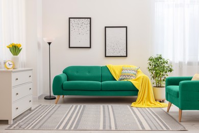 Image of Stylish living room with comfortable sofa and armchair. Interior design