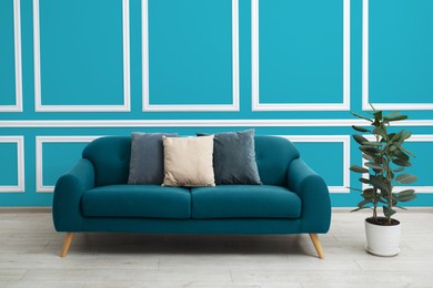 Image of Stylish living room with comfortable sofa and blue wall. Interior design