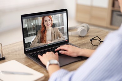 Image of Online psychologist. Woman receiving counselling via video call on laptop at table, closeup