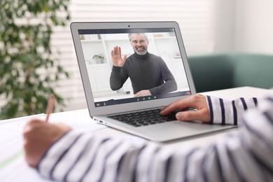 Image of Online psychologist. Woman receiving counselling via video call on laptop at table, closeup
