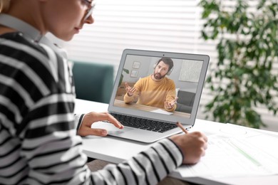 Image of Online psychologist. Woman receiving counselling via video call on laptop at table, closeup