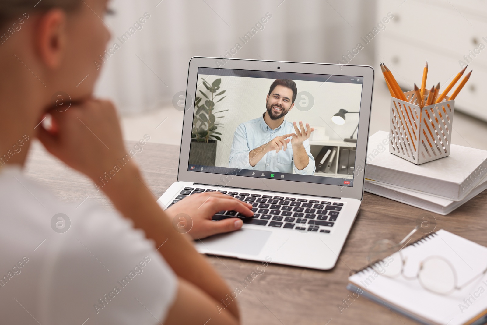 Image of Online psychologist. Woman receiving counselling via video call on laptop at table, closeup