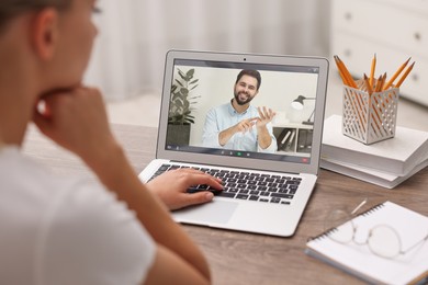 Image of Online psychologist. Woman receiving counselling via video call on laptop at table, closeup