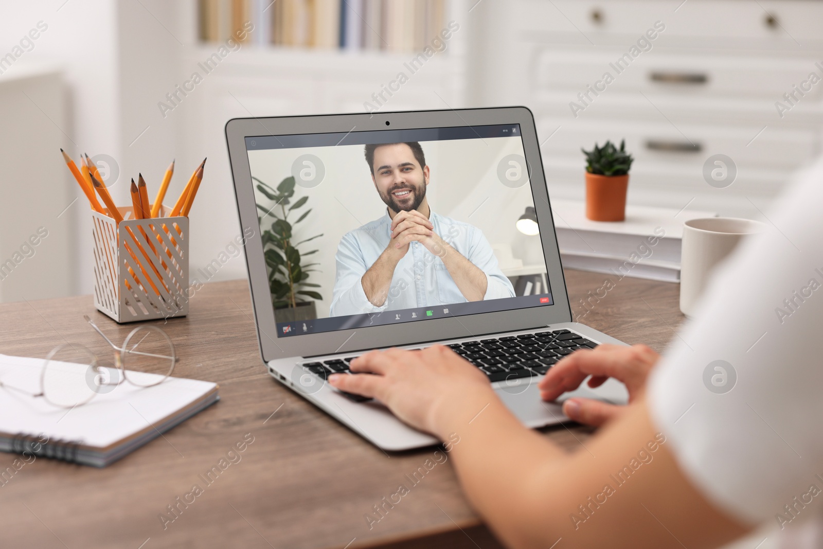 Online psychologist. Woman receiving counselling via video call on laptop at table, closeup Image of Online psychologist. Woman receiving counselling via video call on laptop at table, closeup