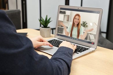 Image of Online psychologist. Woman receiving counselling via video call on laptop at table, closeup