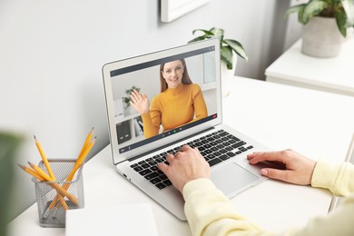 Image of Online psychologist. Woman receiving counselling via video call on laptop at table, closeup