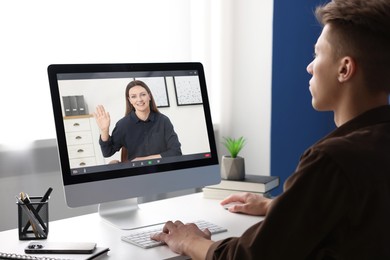 Image of Man having video chat with psychologist via computer at home. Online counselling