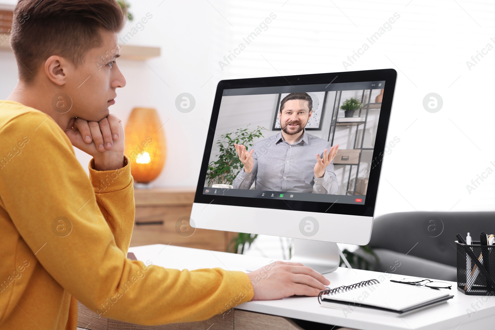Man having video chat with psychologist via computer at home. Online counselling Image of Man having video chat with psychologist via computer at home. Online counselling