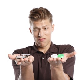 Photo of Man choosing between glasses and contact lenses on white background
