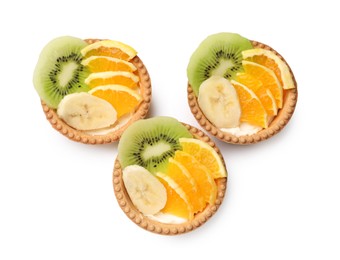 Photo of Tartlets with fruits isolated on white, top view. Delicious dessert
