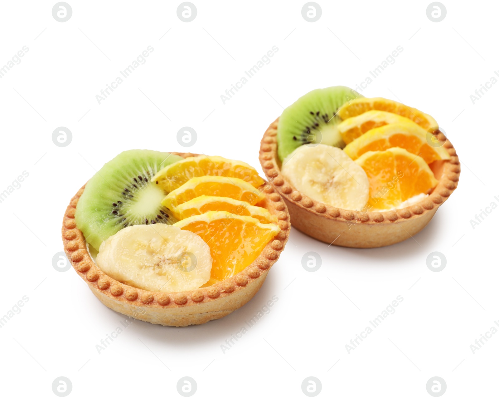 Tartlets with fruits isolated on white. Delicious dessert Photo of Tartlets with fruits isolated on white. Delicious dessert