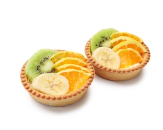 Photo of Tartlets with fruits isolated on white. Delicious dessert