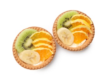 Photo of Tartlets with fruits isolated on white, top view. Delicious dessert
