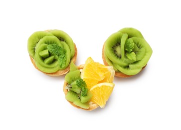 Photo of Tartlets with fruits and mint isolated on white, top view. Delicious dessert
