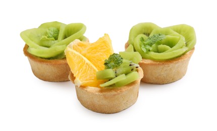Photo of Tartlets with fruits and mint isolated on white. Delicious dessert