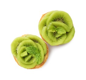 Photo of Tartlets with kiwi and mint isolated on white, top view. Delicious dessert