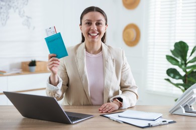 Photo of Travel agent with passport and ticket at wooden table in office