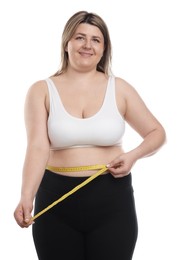 Photo of Weight loss. Plus size woman measuring waist with tape on white background