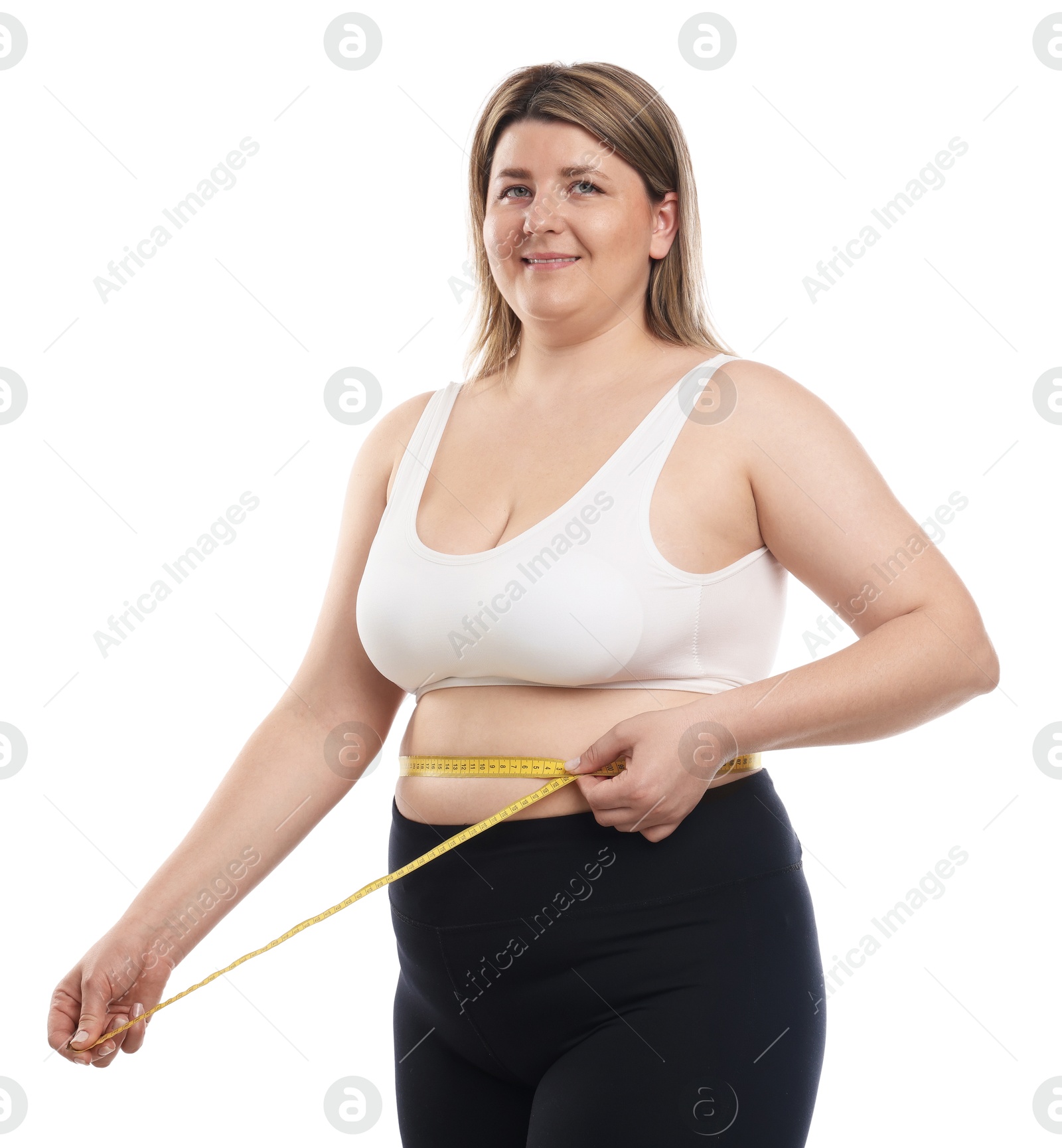 Weight loss. Plus size woman measuring waist with tape on white background Photo of Weight loss. Plus size woman measuring waist with tape on white background
