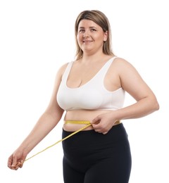 Photo of Weight loss. Plus size woman measuring waist with tape on white background