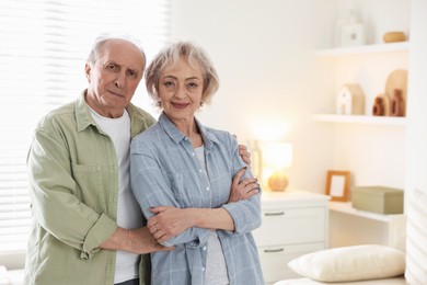Photo of Portrait of lovely senior couple at home, space for text